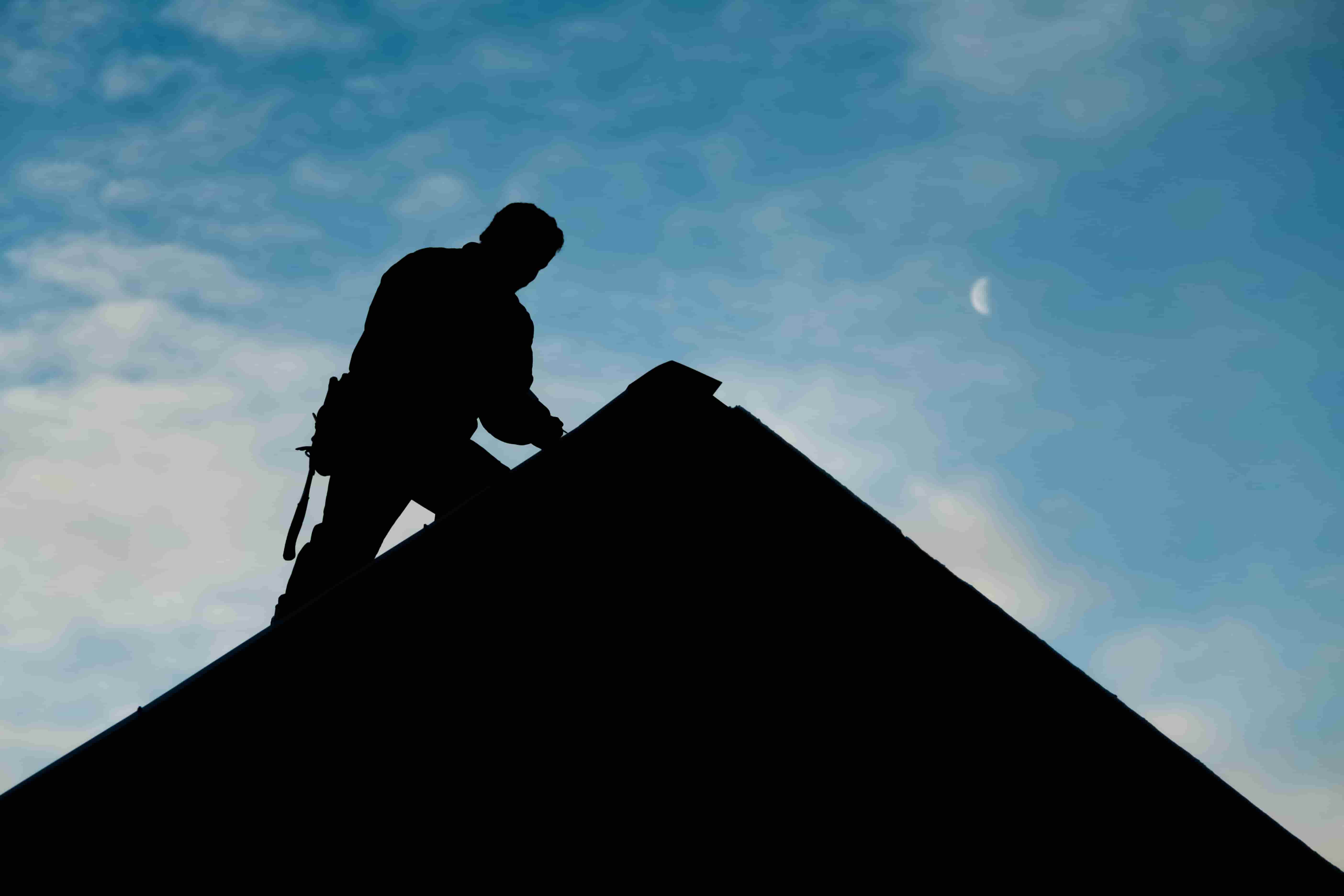 Roofing repair Langley silhouette of man working on a roof